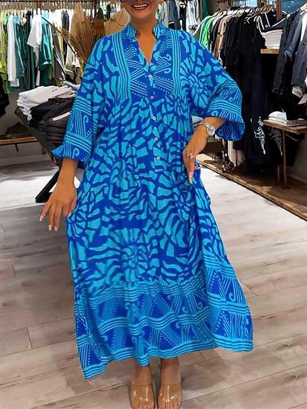 Blue Irene™ Vibrant Printed Dress by Lumina Vancouver, featuring bold floral patterns and a flowing silhouette.