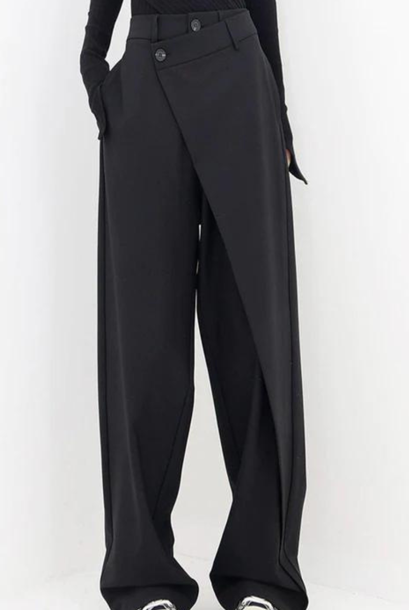 Black Isabella Lumina Wear chic asymmetric wide-leg trousers, shown on a model with a sleek, modern fit and stylish design.