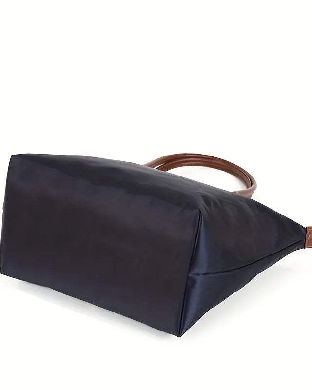 Isabella Lumina black faux leather handbag with spacious interior, stylish design, and top handles for versatile everyday use.