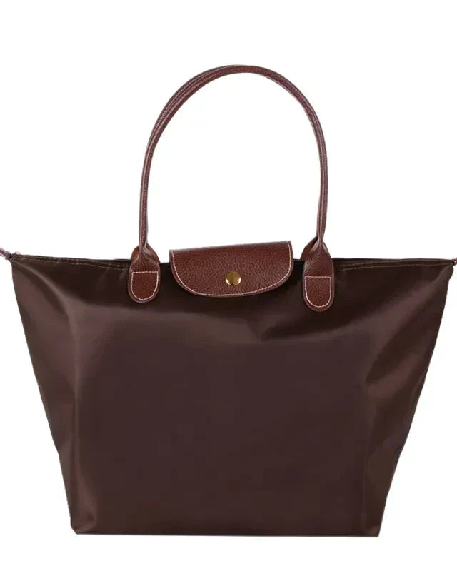 Isabella Lumina black faux leather handbag with spacious interior and stylish design, featuring sturdy handles and modern details.