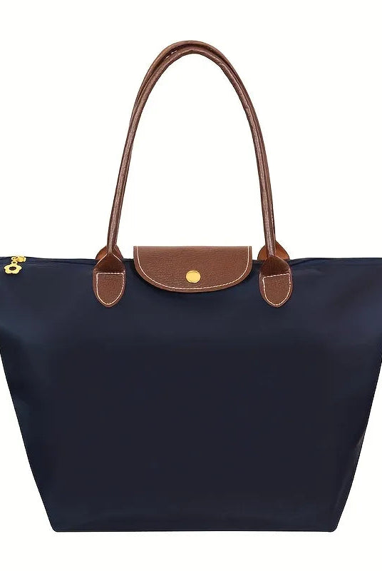 Black faux leather handbag named Isabella by Lumina Wear, featuring a spacious design and chic style.
