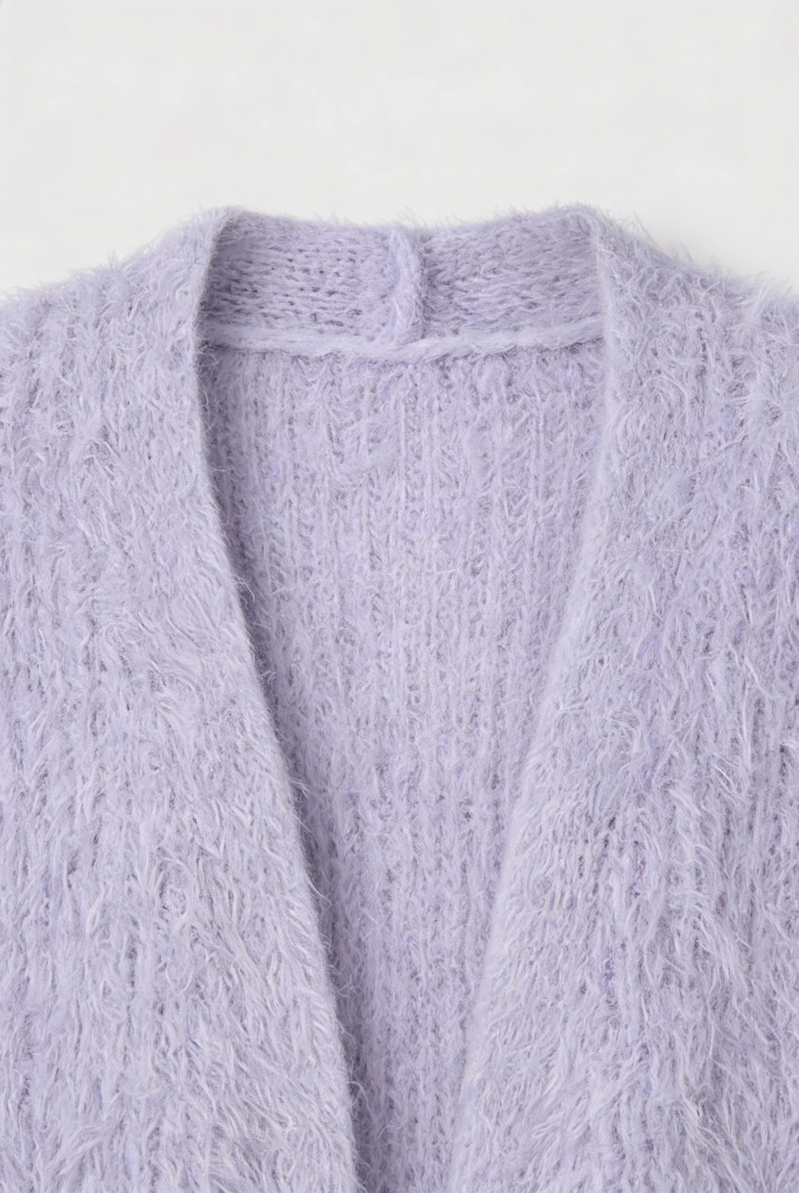 Cozy purple knit cardigan with ribbed details from Lumina Wear, featuring a relaxed fit and textured fabric for comfort and style.