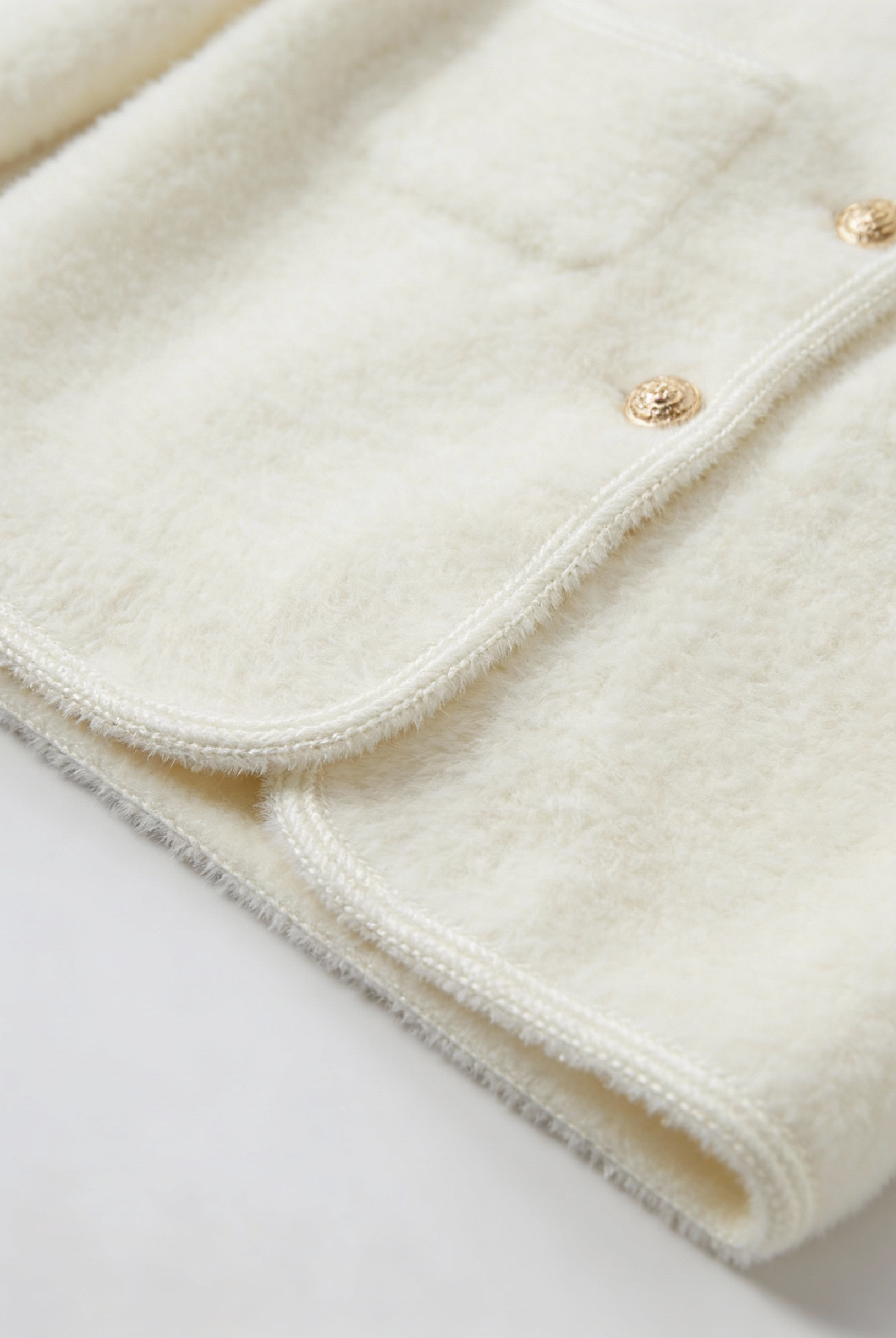 White women's cardigan sweater with ribbed hem from Lumina Wear, featuring a cozy fit and soft knit fabric.