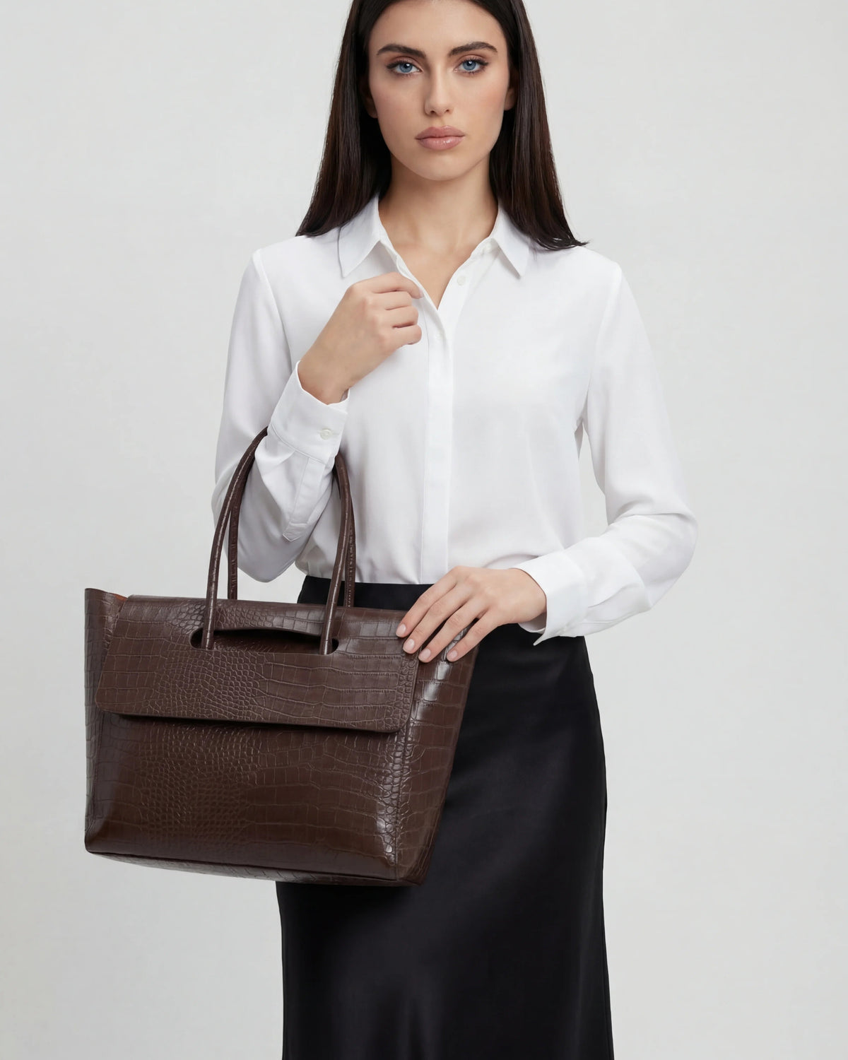Elegant black crocodile leather handbag with adjustable strap from Lumina Wear, featuring a stylish design and polished finish.
