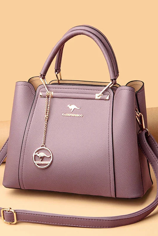 Elegant black leather handbag with gold accents from Lumina Wear's Isabella collection, showcasing a stylish and sophisticated design.