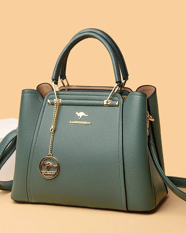 Elegant black leather handbag with gold accents from Lumina Wear, featuring a structured design and top handle.