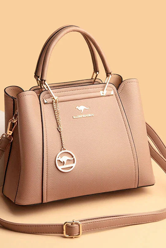 Elegant black leather handbag with gold accents from Lumina Wear's Isabella collection, showing the sleek design and gold hardware.