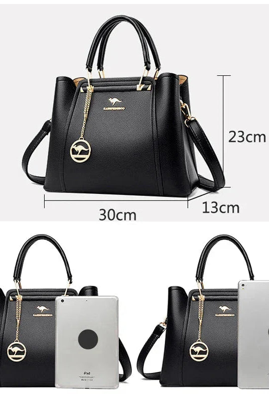 Elegant black leather handbag by Lumina Wear featuring gold accents, with structured design and top handle for versatile style.