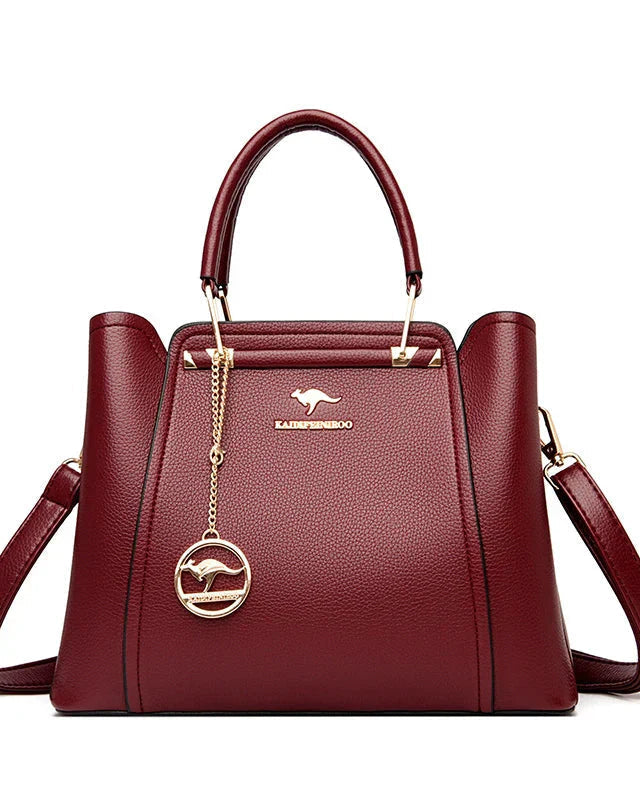 Elegant black leather handbag with gold accents from Lumina Wear, featuring a sleek design and top handle.
