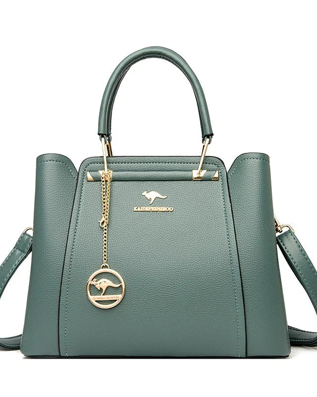 Elegant black leather handbag with gold accents by Lumina Wear, featuring a sleek design and stylish metal hardware.