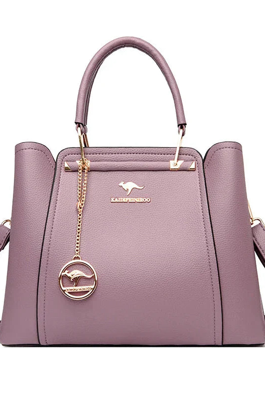 Elegant black leather handbag with gold accents by Lumina Wear, featuring a structured design and stylish details.