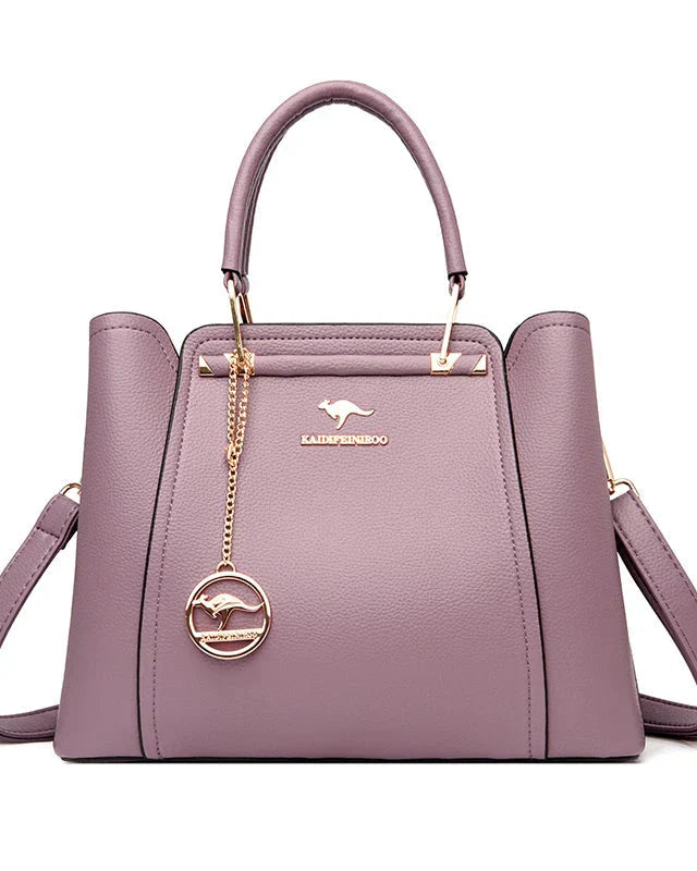 Elegant black leather handbag with gold accents from Lumina Wear, featuring a structured design and stylish handles.