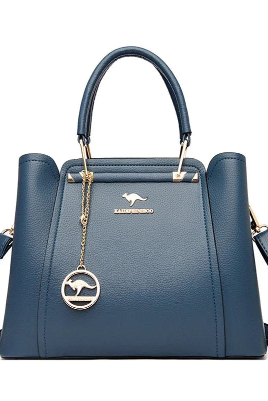 Elegant black leather handbag with gold accents from Lumina Wear's Isabella collection, featuring a structured design and stylish details.