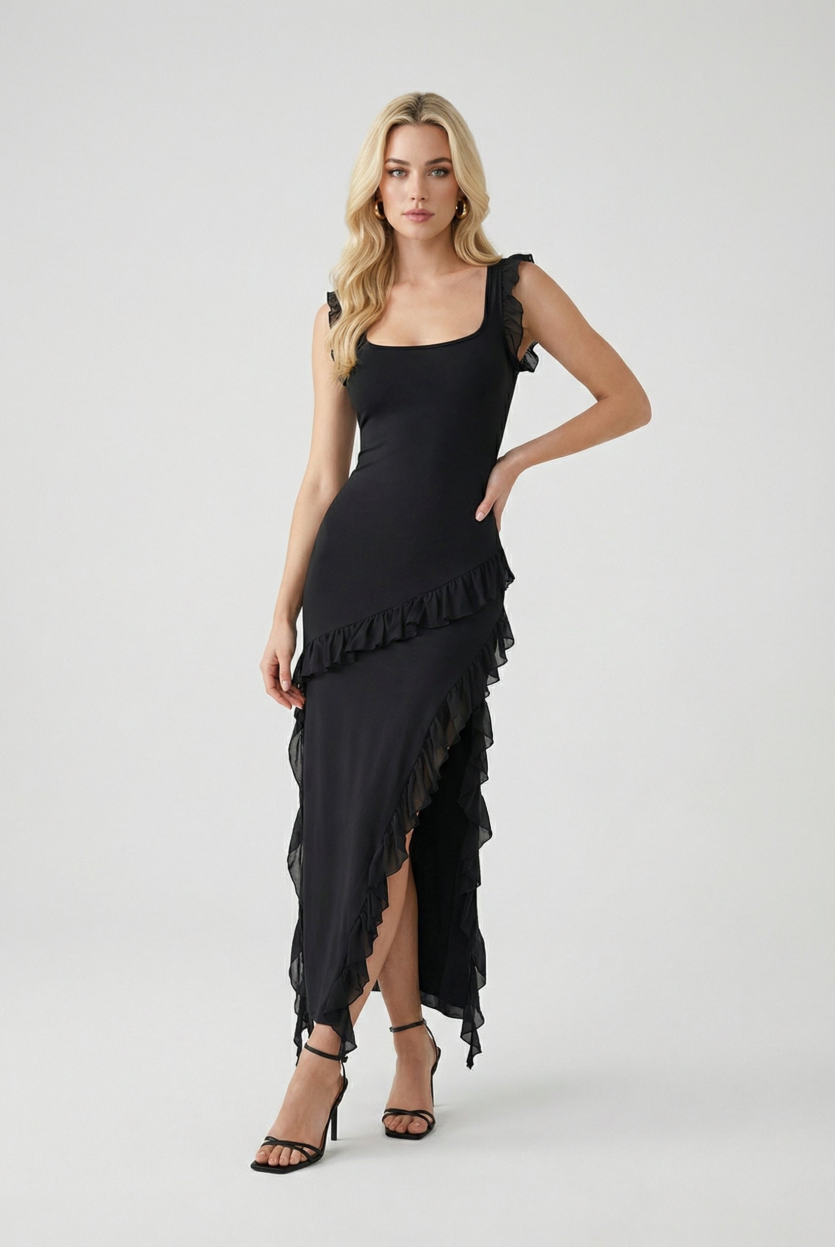 Elegant black maxi dress with high slit from Lumina Wear, featuring a flowing fabric and sleek silhouette for women's fashion.