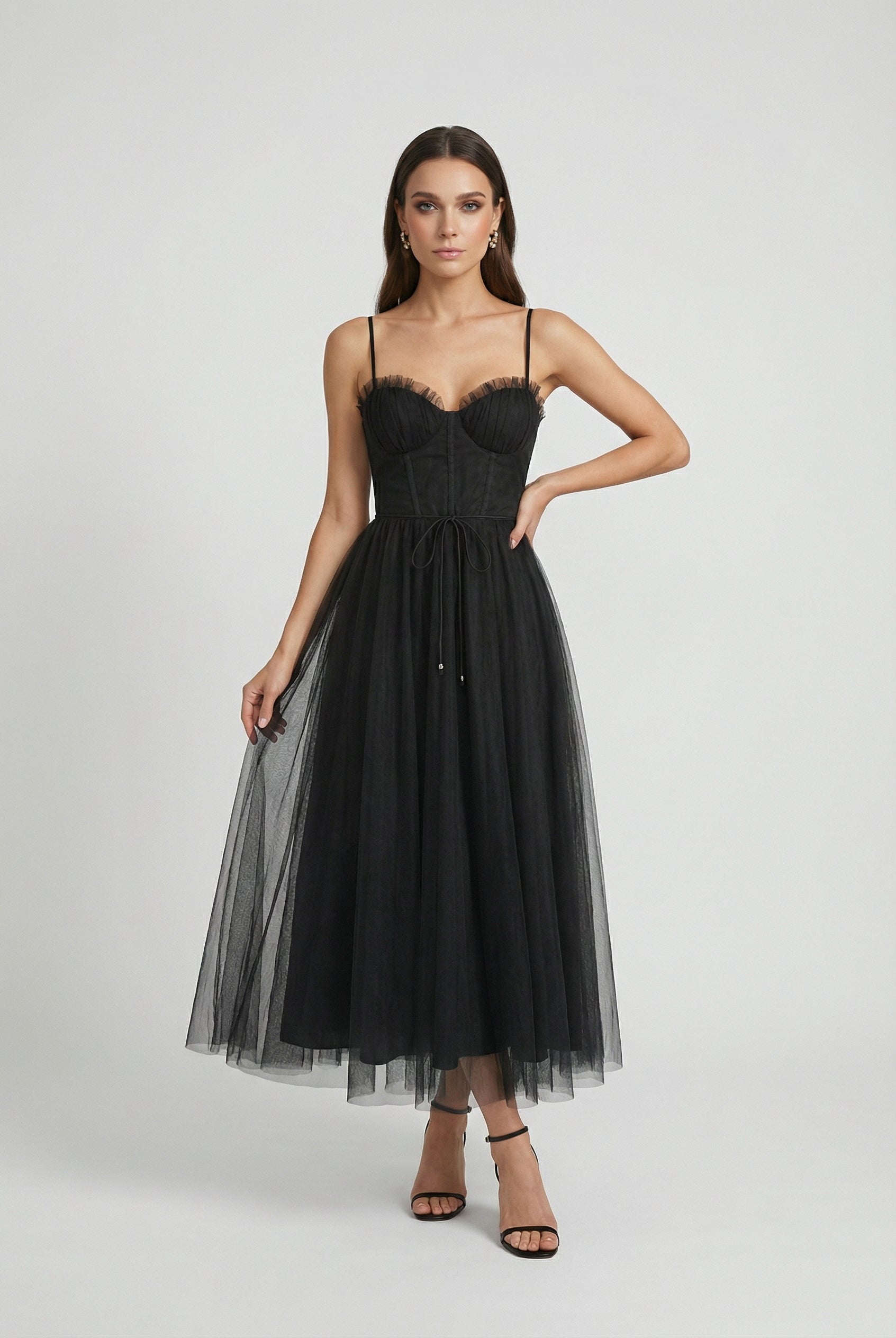 Elegant black midi dress with sleeveless design by Lumina Wear, featuring a fitted silhouette and stylish details.