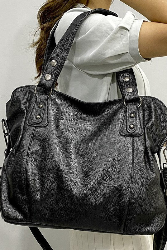 Elegant black synthetic leather tote bag by Lumina Wear featuring sleek design and spacious interior for versatile use.