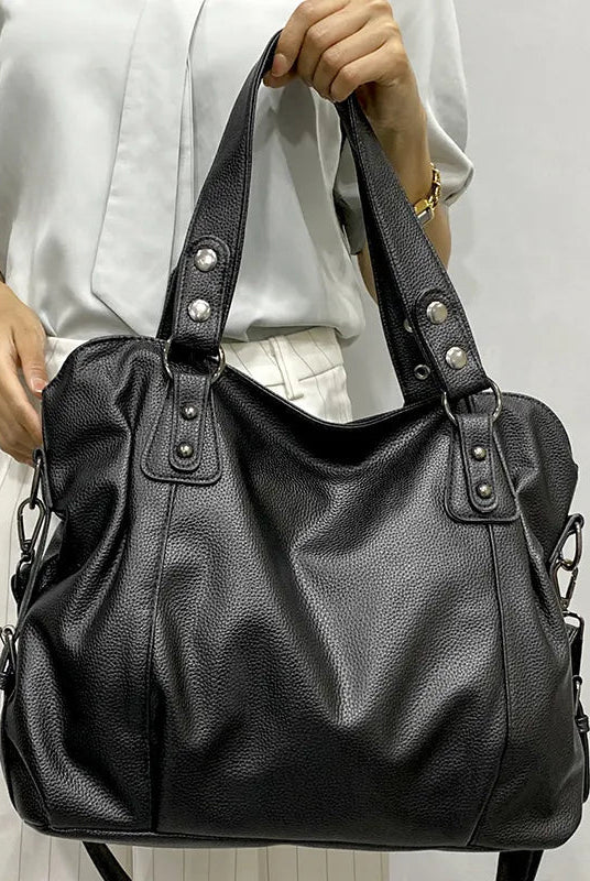 Elegant black synthetic leather tote bag from Lumina Wear, featuring a spacious design and sturdy handles.