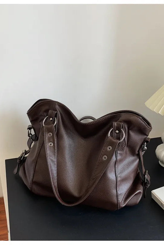 Elegant black synthetic leather tote bag by Lumina Wear, featuring a spacious design and sleek handles for versatile use.