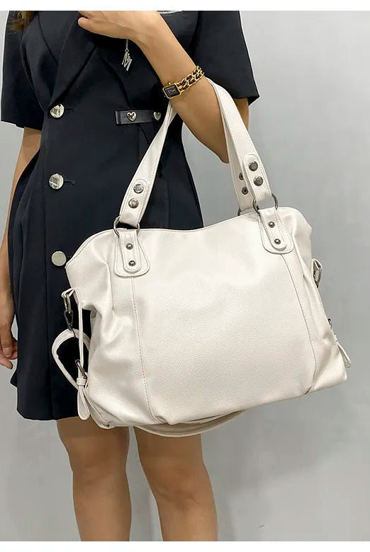 Elegant black synthetic leather tote bag named Isabella by Lumina Wear, showcasing its sleek design and spacious interior.
