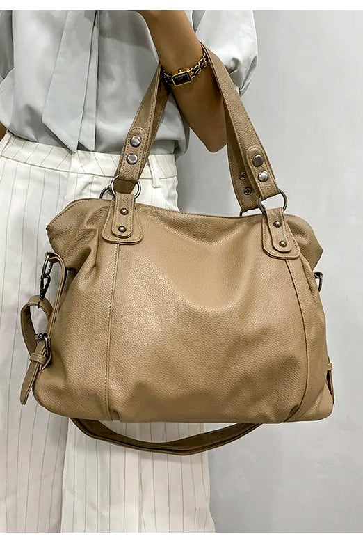 Black synthetic leather tote bag named Isabella by Lumina Wear, stylish handbag with sleek design and spacious interior.