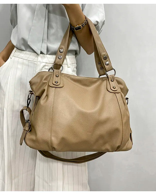 Elegant black synthetic leather tote bag by Lumina Wear featuring a spacious design and stylish handles.