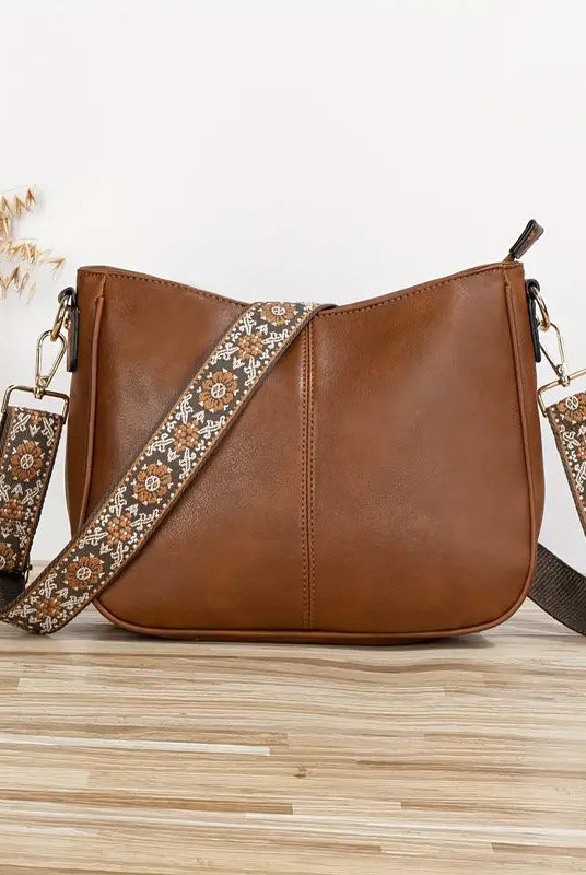 Elegant black vegan leather shoulder bag by Lumina Wear with adjustable strap, featuring a sleek design and spacious interior.