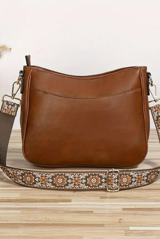 Elegant black vegan leather shoulder bag by Lumina Wear featuring an adjustable strap and stylish design.