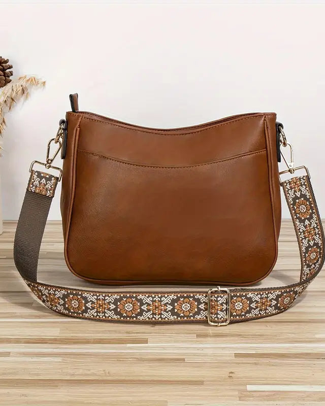 Elegant black vegan leather shoulder handbag by Lumina Wear with an adjustable strap and stylish design.