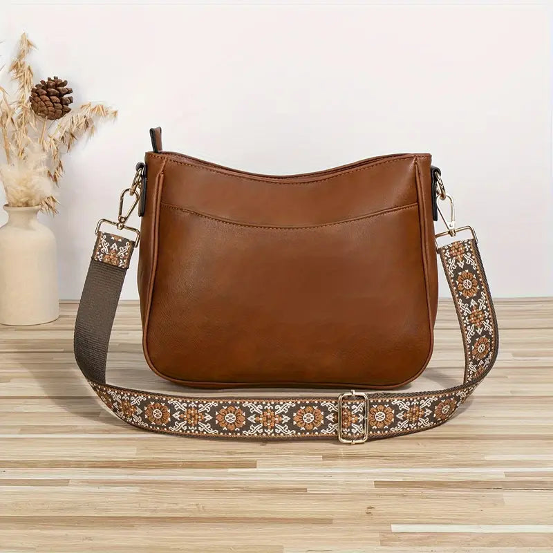 Elegant black vegan leather shoulder bag by Lumina Wear featuring an adjustable strap and stylish design.