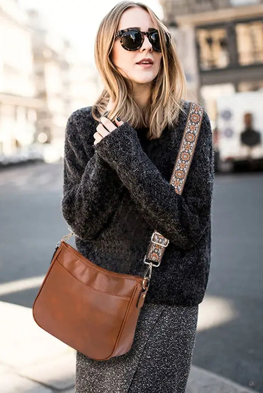Black vegan leather shoulder bag with adjustable strap, elegant design from Lumina Wear's Isabella handbag collection.