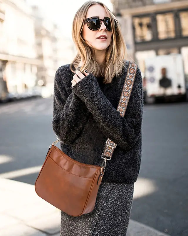 Elegant black vegan leather shoulder handbag by Lumina Wear, featuring an adjustable strap and stylish design.