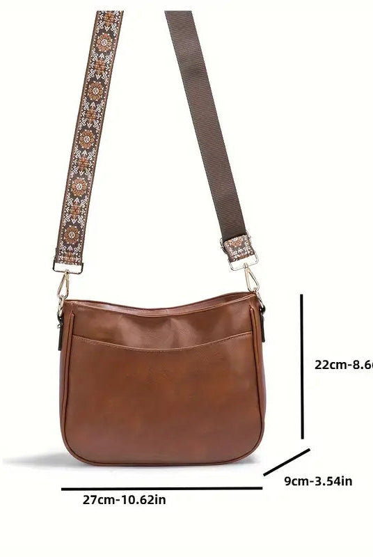 Elegant black vegan leather shoulder bag with adjustable strap from Lumina Wear, featuring a stylish design and spacious interior.