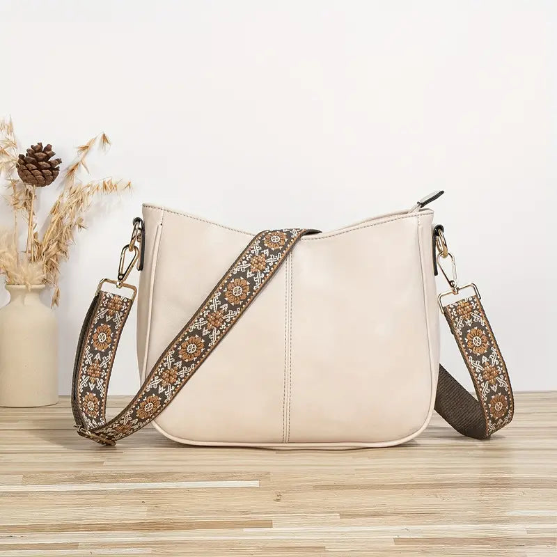 Elegant black vegan leather shoulder bag by Lumina Wear featuring an adjustable strap and sleek design.
