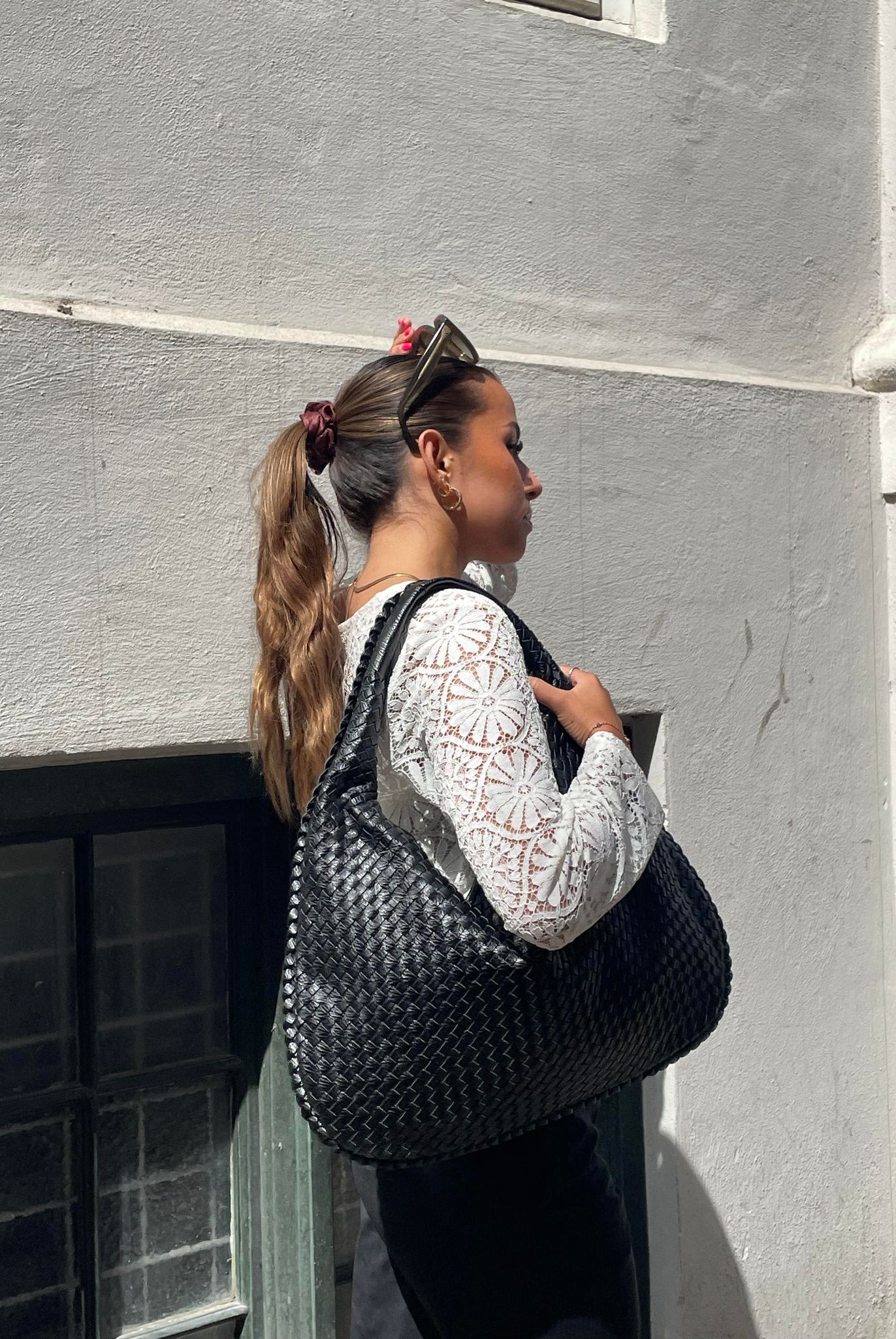 Elegant black vegan leather tote bag from Lumina Wear, spacious handbag with sleek design and sturdy handles.