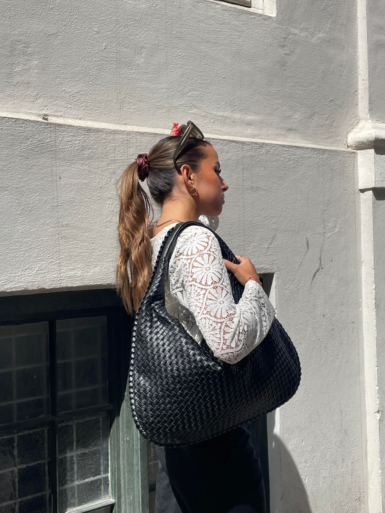 Elegant black vegan leather tote bag from Lumina Wear, spacious handbag with sleek design and sturdy handles.
