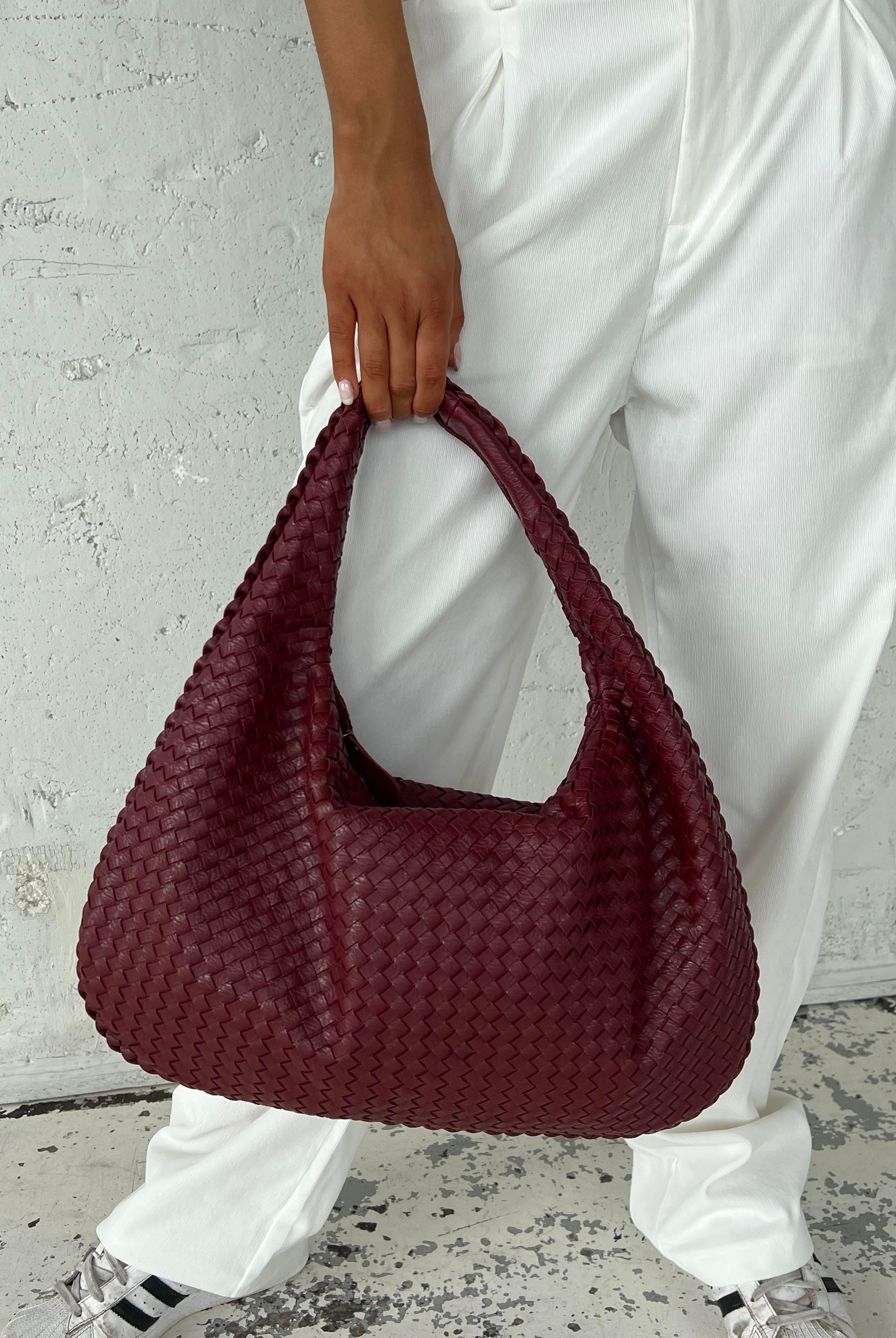 Elegant black vegan leather tote bag by Lumina Wear, featuring a spacious design and sturdy handles for versatile use.
