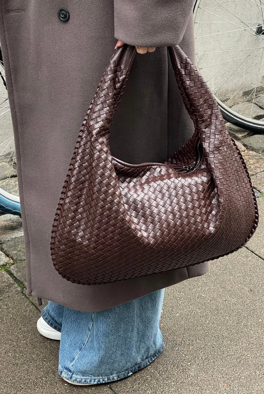 Elegant black vegan leather tote bag by Lumina Wear, featuring spacious interior and sturdy handles, perfect for everyday use.