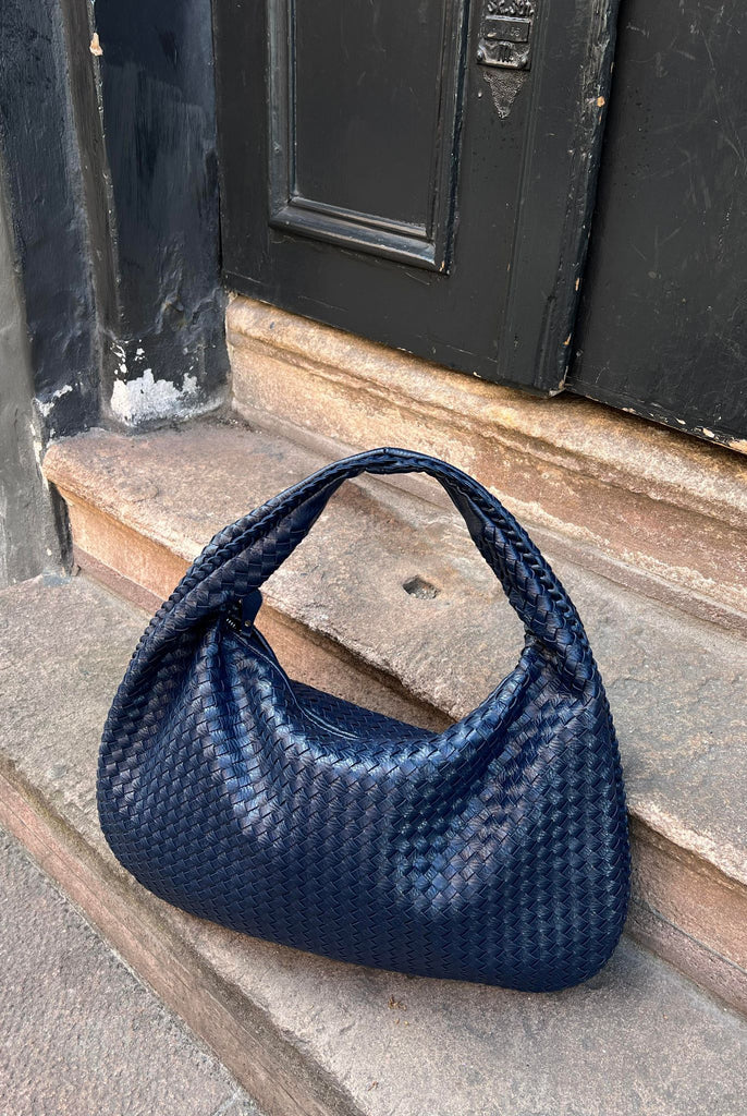 Elegant black vegan leather tote bag from Lumina Wear, Isabella handbag with spacious interior and sleek design.