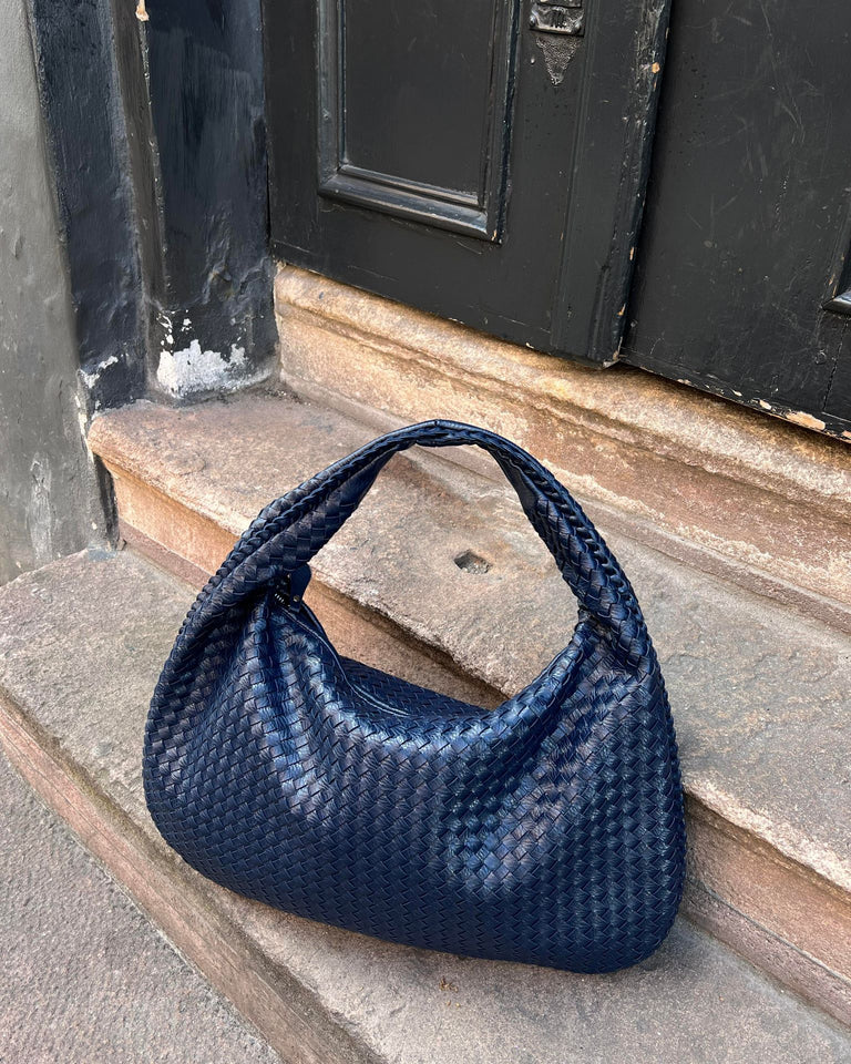 Elegant black vegan leather tote bag by Lumina Wear, showcasing spacious interior and sleek design, perfect for everyday use.