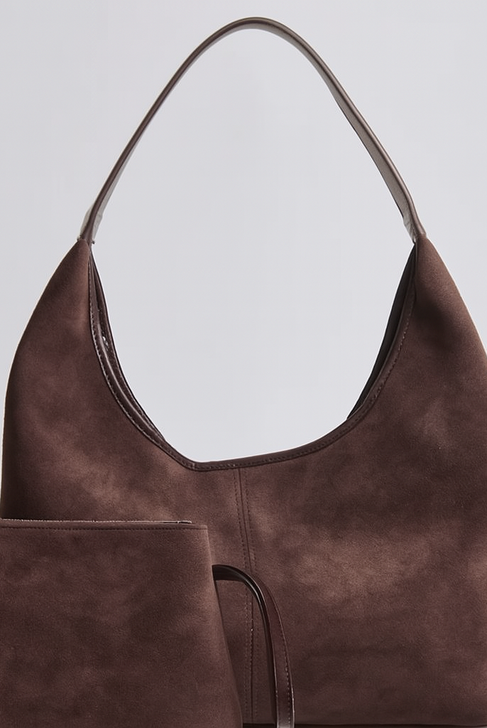 Elegant black vegan suede tote bag from Lumina Wear, featuring a spacious design and sleek hand-held style.