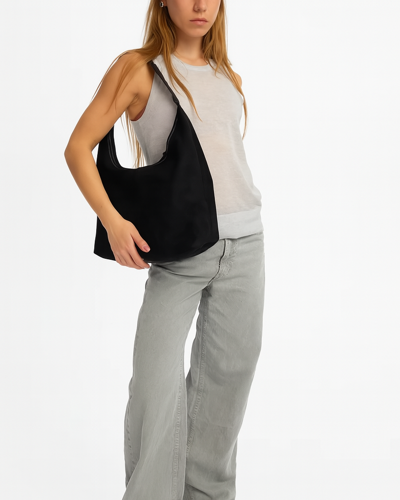 Elegant black vegan suede tote bag by Lumina Wear, showcasing a spacious handbag with sleek design and sturdy handles.