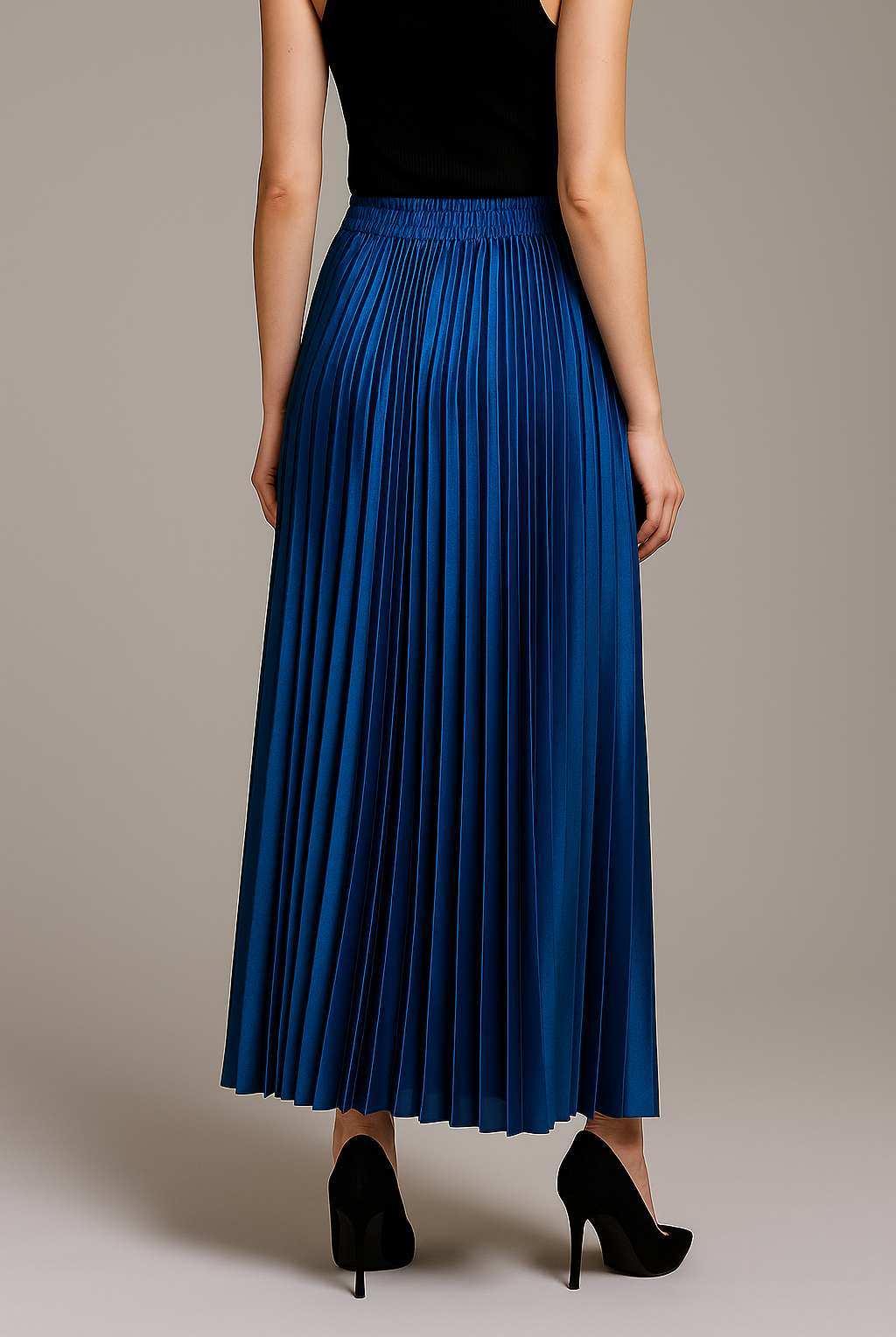 Gold high waist pleated maxi skirt from Lumina Wear, styled with flowing fabric and elegant pleats.