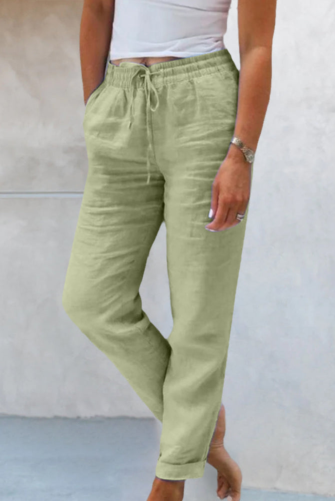 Isabella beige lightweight linen trousers by Lumina Wear, tailored fit with a relaxed style, shown on a model.
