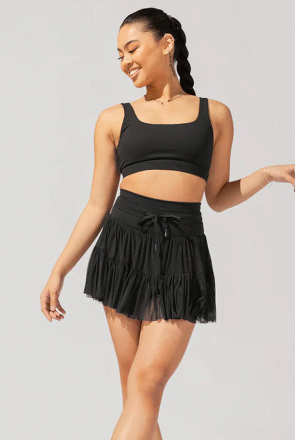 Light brown Isabella Lumina Wear elegant pleated mini skirt with integrated shorts, stylish and comfortable for casual or dressy looks.