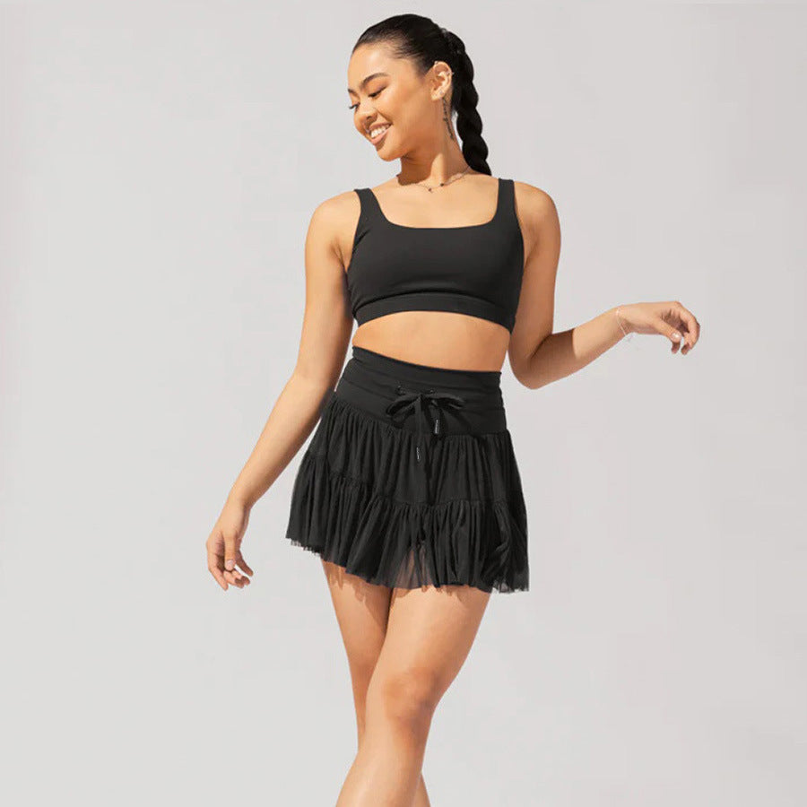 Light brown Isabella Lumina Wear elegant pleated mini skirt with integrated shorts, stylish and comfortable for casual or dressy looks.