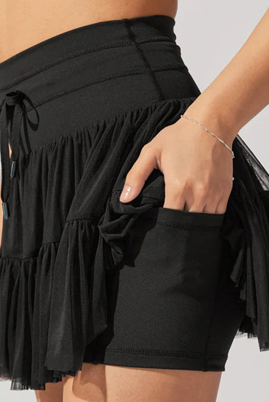 Light brown Isabella Lumina Wear pleated mini skirt with integrated shorts, stylish and elegant for casual or dressy outfits.