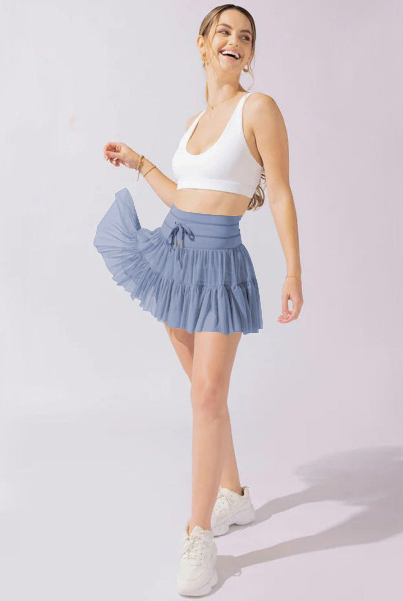 Light brown Isabella pleated mini skirt with integrated shorts from Lumina Wear, featuring a stylish, elegant design.