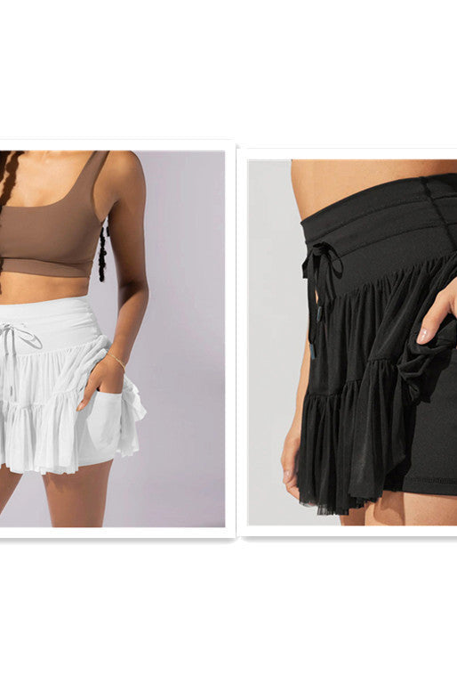 Light brown Isabella elegant pleated mini skirt with integrated shorts from Lumina Wear, showcasing a stylish and comfortable design.