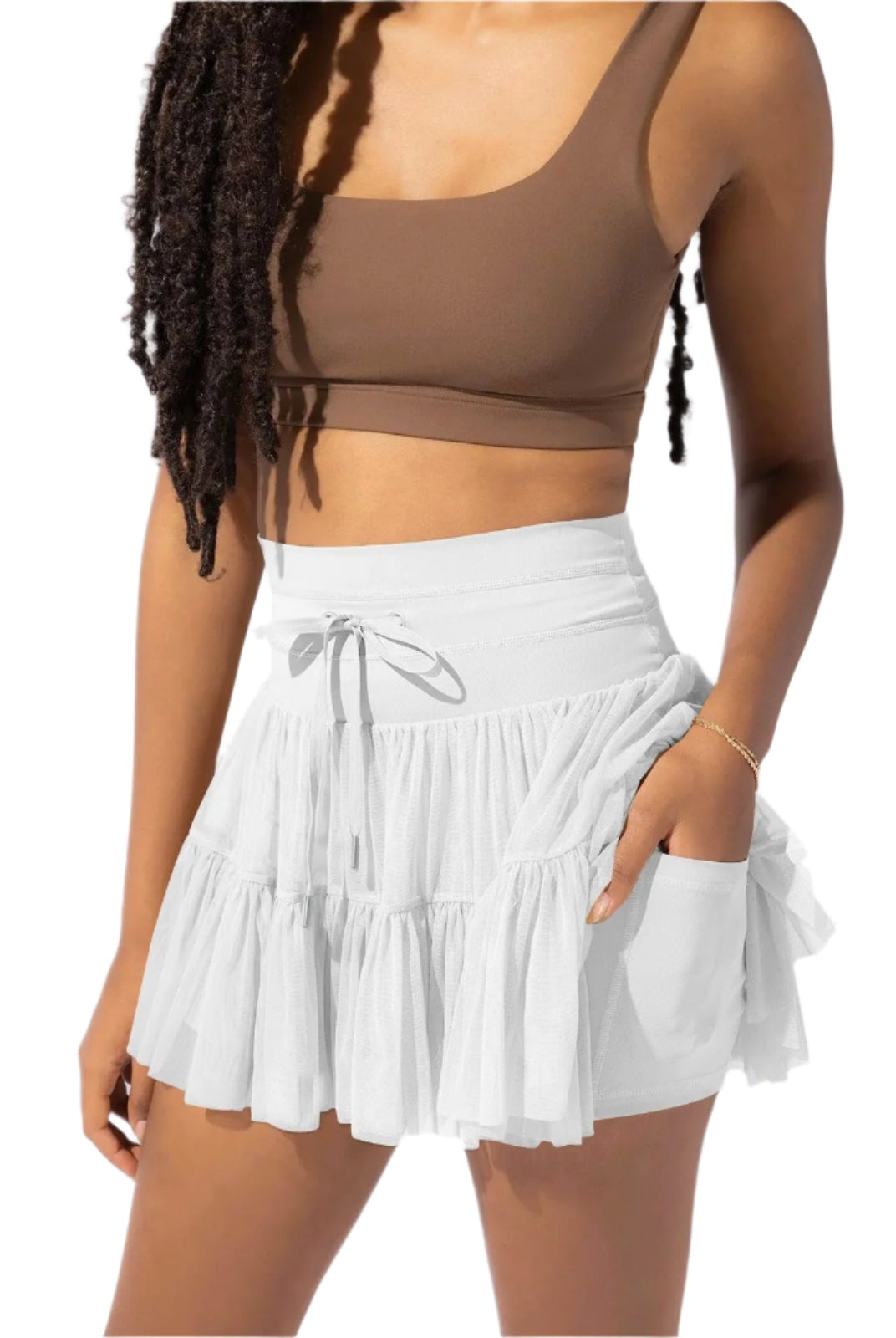 Light brown Isabella Lumina Wear pleated mini skirt with integrated shorts, showcasing elegant pleats and stylish design.