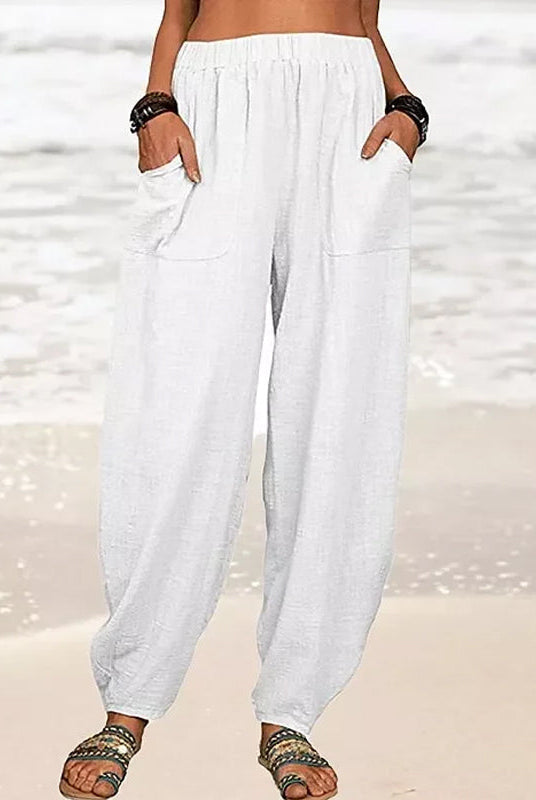 High-waisted black harem trousers from Lumina Wear featuring a casual fit and relaxed style, shown in white in the image.
